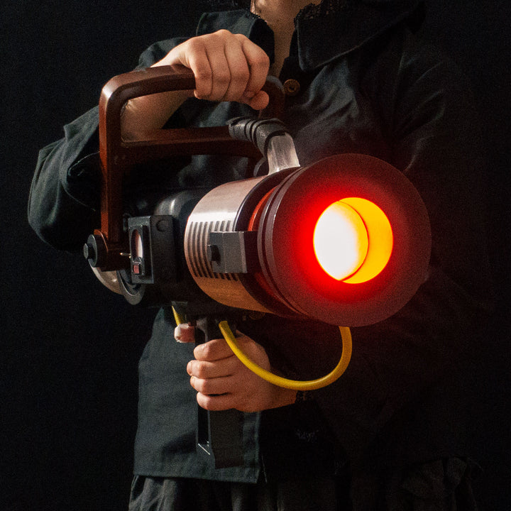 Arkan holding a Team Fortress 2 cosplay prop Quick Fix from Meet the Real Medic from the red team