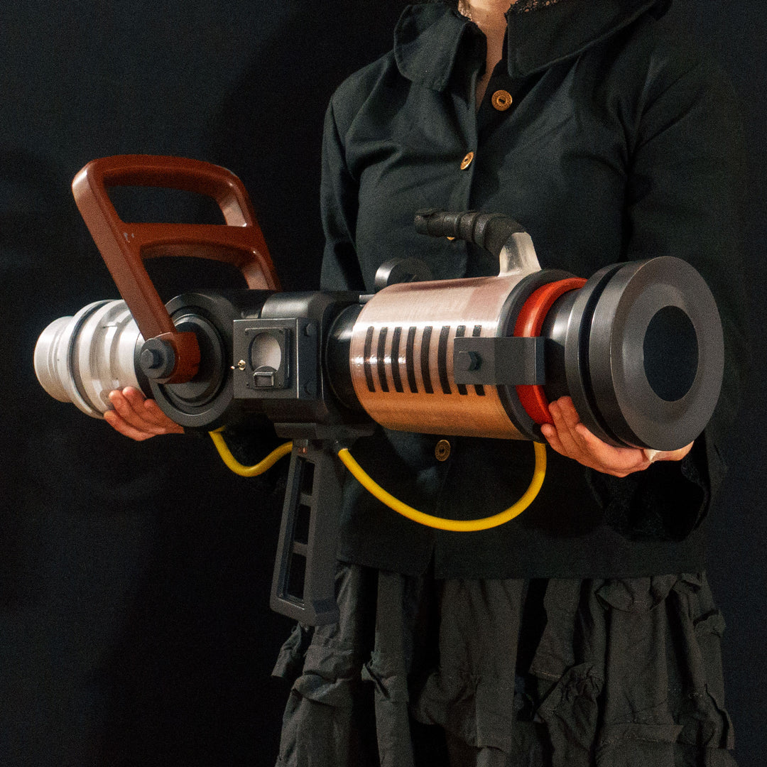 Arkan holding a Team Fortress 2 cosplay prop Quick Fix from Meet the Real Medic from the red team