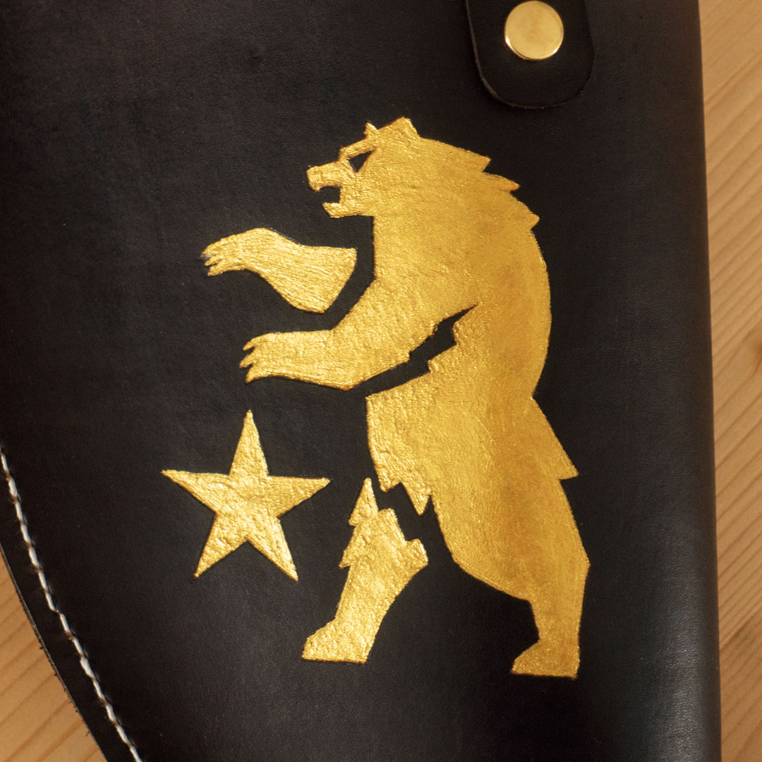 An engraved leather for our FNV inspired Ranger Sequoia cosplay prop, all filed later over the bear logo with golden pigments and hand sewn.