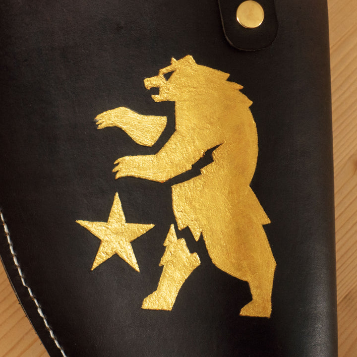 An engraved leather for our FNV inspired Ranger Sequoia cosplay prop, all filed later over the bear logo with golden pigments and hand sewn.