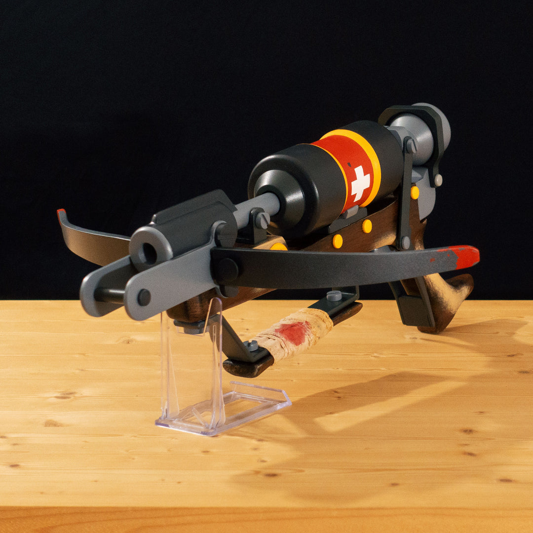 A TF2 Medic Crusader's Crossbow prop for cosplay or collection with a removable fake syringe bolt! Has all the little details from in-game like the bloody rag wrapped around the front wooden handle or small scuff all around.