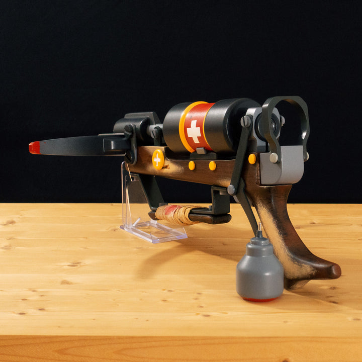A TF2 Medic Crusader's Crossbow prop for cosplay or collection with a removable fake syringe bolt! Has all the little details from in-game like the bloody rag wrapped around the front wooden handle or small scuff all around.