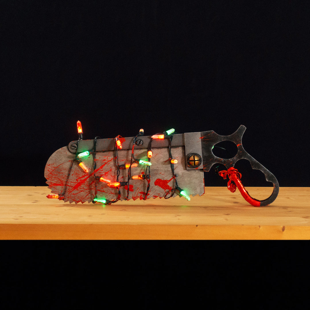 A TF2 Medic Bone Saw cosplay prop with a metal paint job! Comes in Festive and bloodied version!