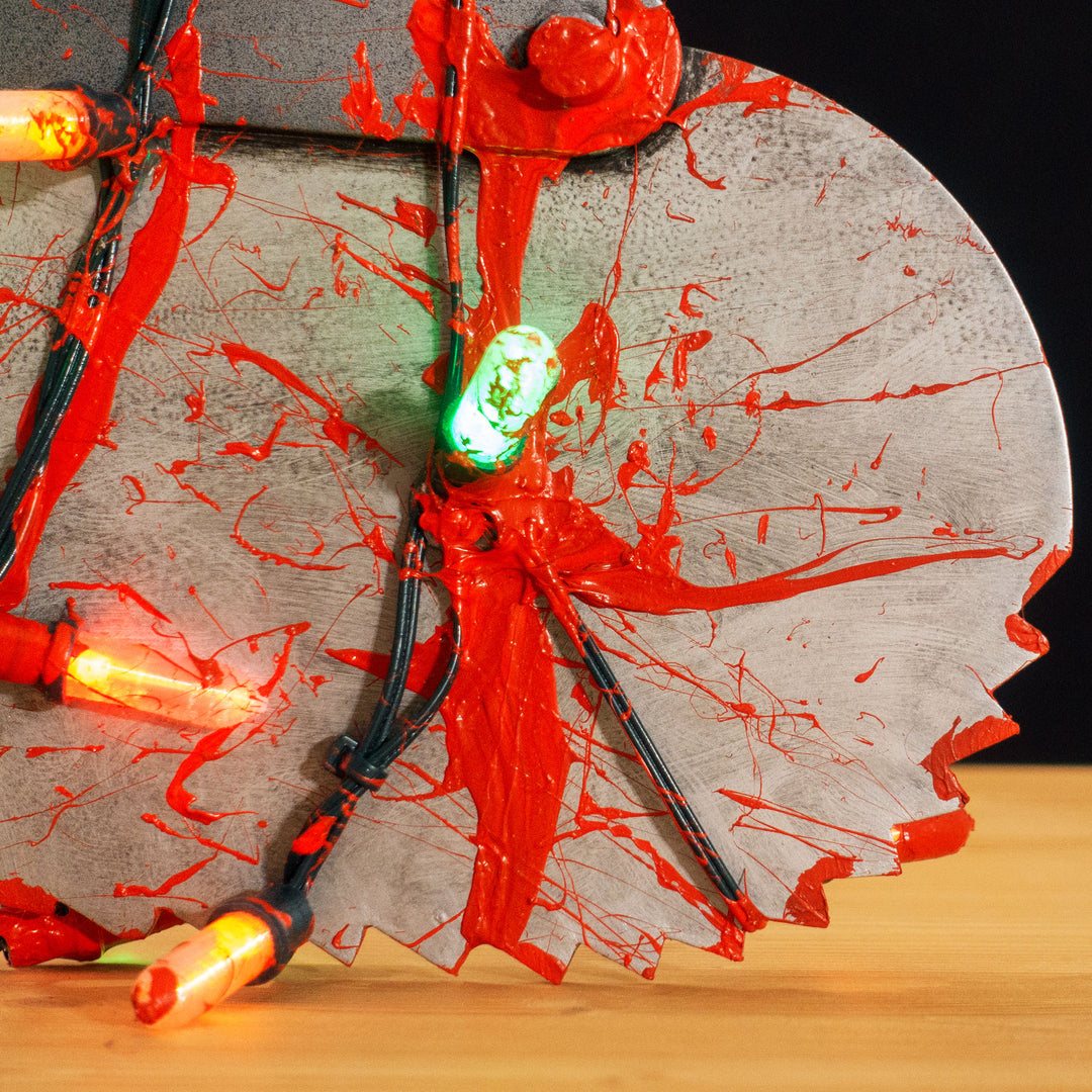 A TF2 Medic Bone Saw cosplay prop with a metal paint job! Comes in Festive and bloodied version!