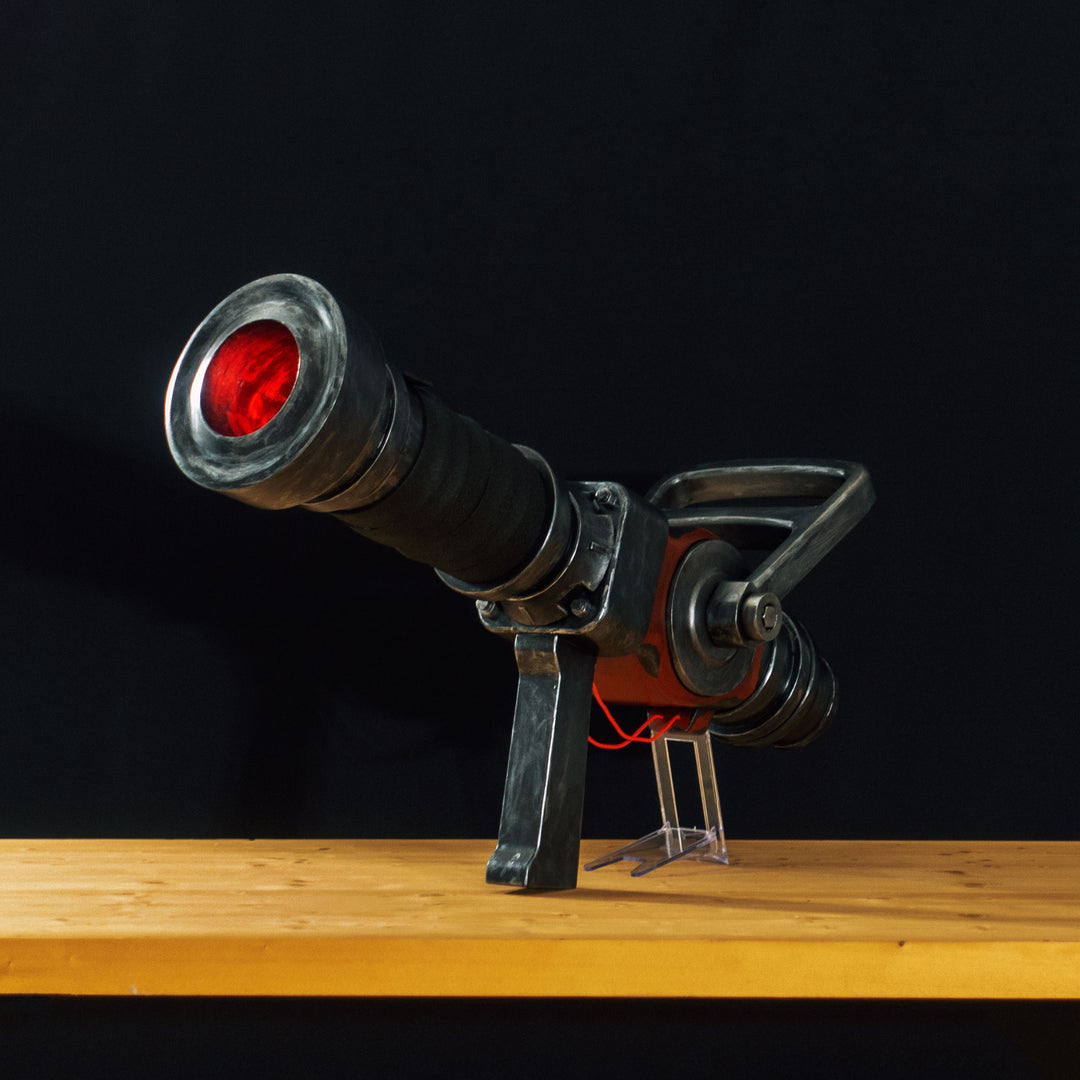 A TF2 Medic Medigun cosplay prop with a metal paint job that glows with 2 lights positions.