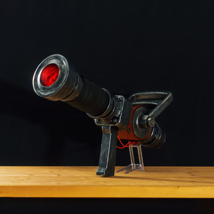 A TF2 Medic Medigun cosplay prop with a metal paint job that glows with 2 lights positions.