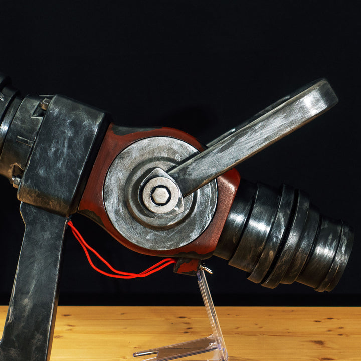 A TF2 Medic Medigun cosplay prop with a metal paint job that glows with 2 lights positions.