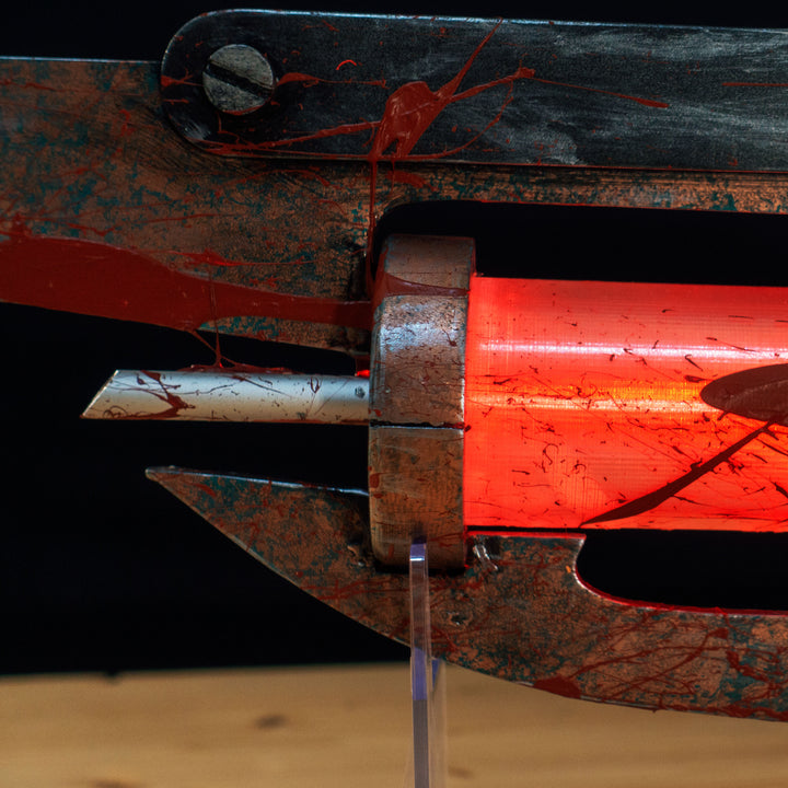 A TF2 Medic Übersaw prop with a metal paint job. Comes in Festive and with out without blood effects!