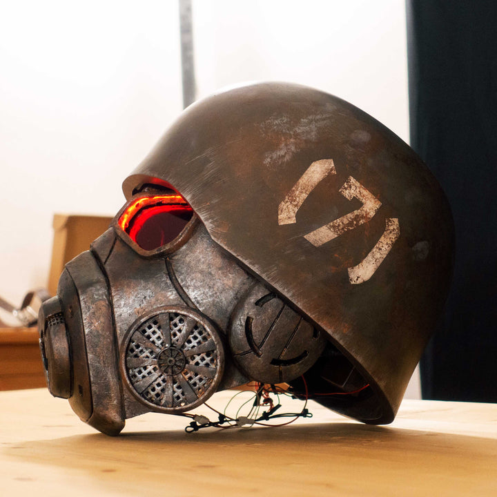 An Inspired Fallout New Vegas 2 parts helmet featuring the well knows NCR Ranger Helmet function. Lenses glow no matter the light, and it has side lights on the right side controlled at the right ear piece control panel. Has a fan inside to wick out moisture so you can be comfortable while wearing it for extended period of time. inside is padded with vegetable leather and a chin strap for align your vision with the lenses no matter your build.