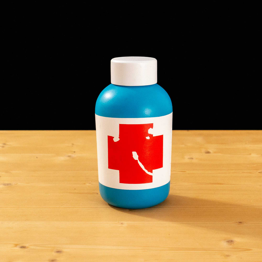A TF2 Small Health Kit Replica Props for cosplay featuring its blue body, the white cap and white label with a chipped red cross.