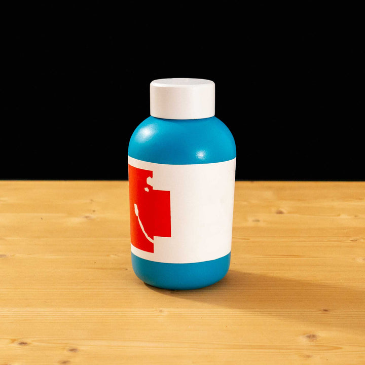 A TF2 Small Health Kit Replica Props for cosplay featuring its blue body, the white cap and white label with a chipped red cross.