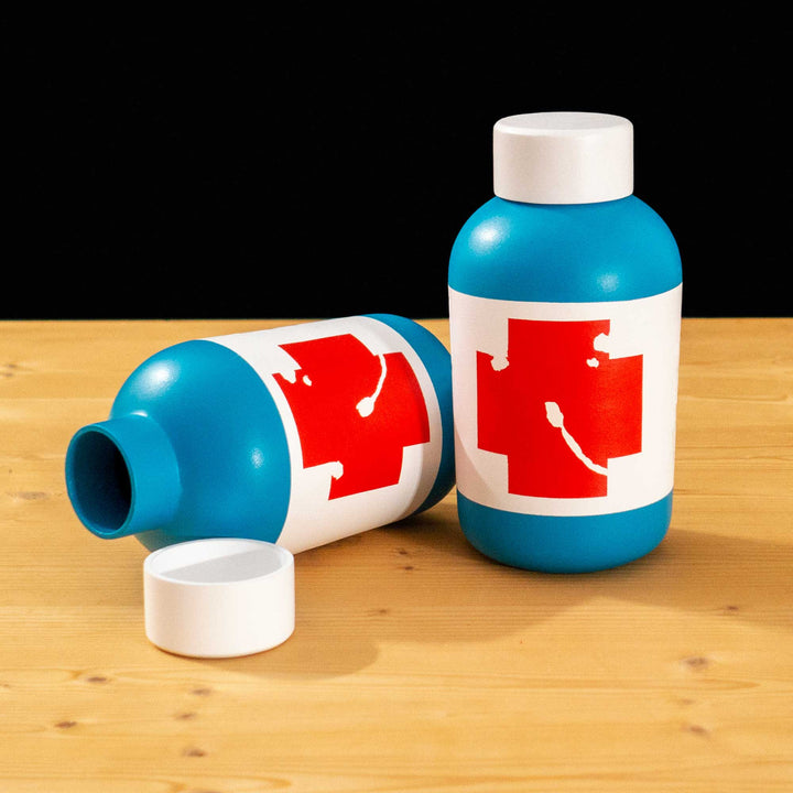 A TF2 Small Health Kit Replica Props for cosplay featuring its blue body, the white cap and white label with a chipped red cross.