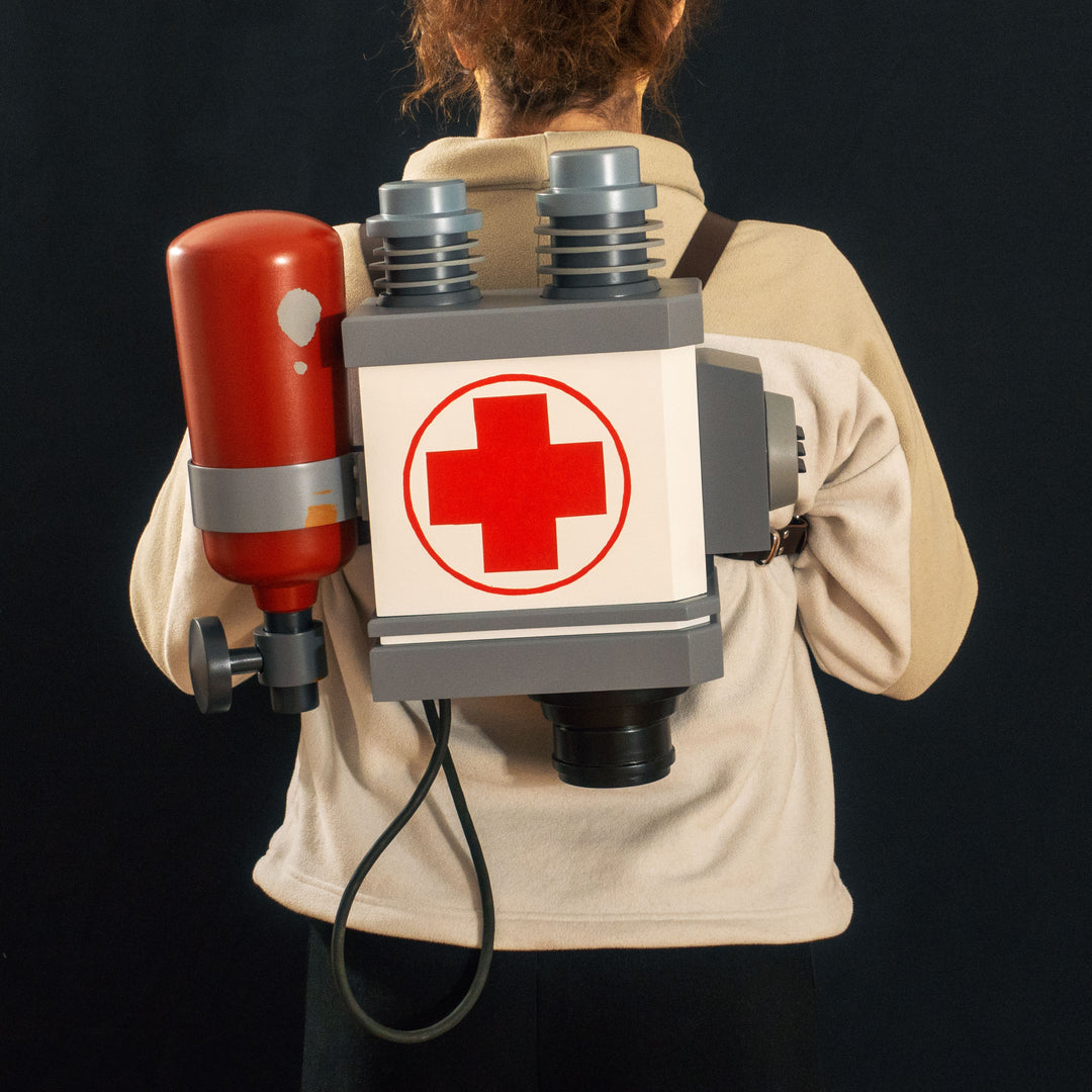 A TF2 Medic Backpack cosplay prop ready to be worn with its leather straps.