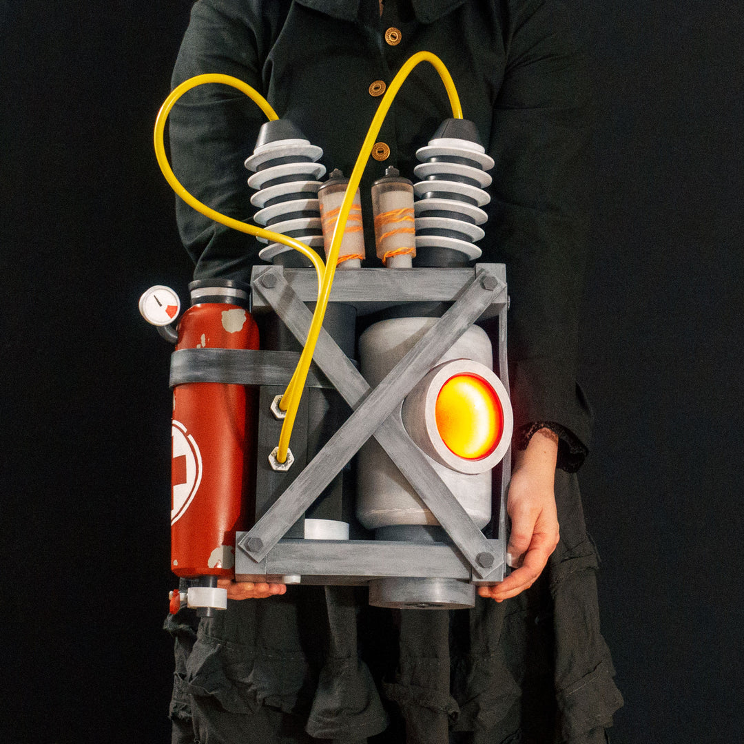Arkan holding a Team Fortress 2 cosplay prop Quick Fix Backpack from Meet the Real Medic from the red team