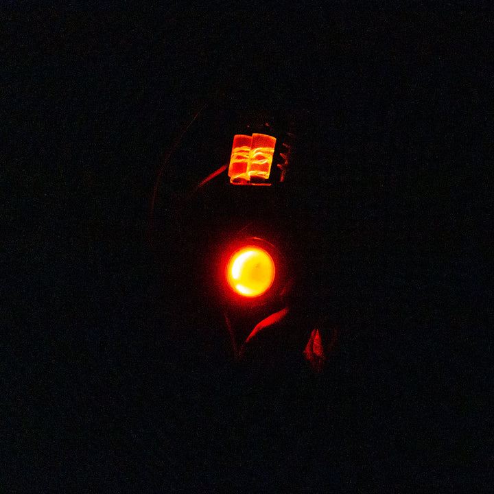 Arkan holding a Team Fortress 2 cosplay prop Quick Fix Backpack from Meet the Real Medic from the red team in the dark