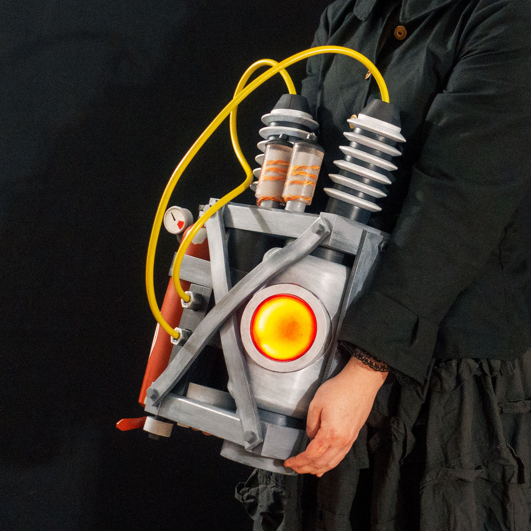 Arkan holding a Team Fortress 2 cosplay prop Quick Fix Backpack from Meet the Real Medic from the red team