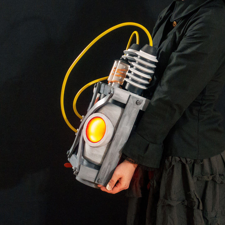 Arkan holding a Team Fortress 2 cosplay prop Quick Fix Backpack from Meet the Real Medic from the red team