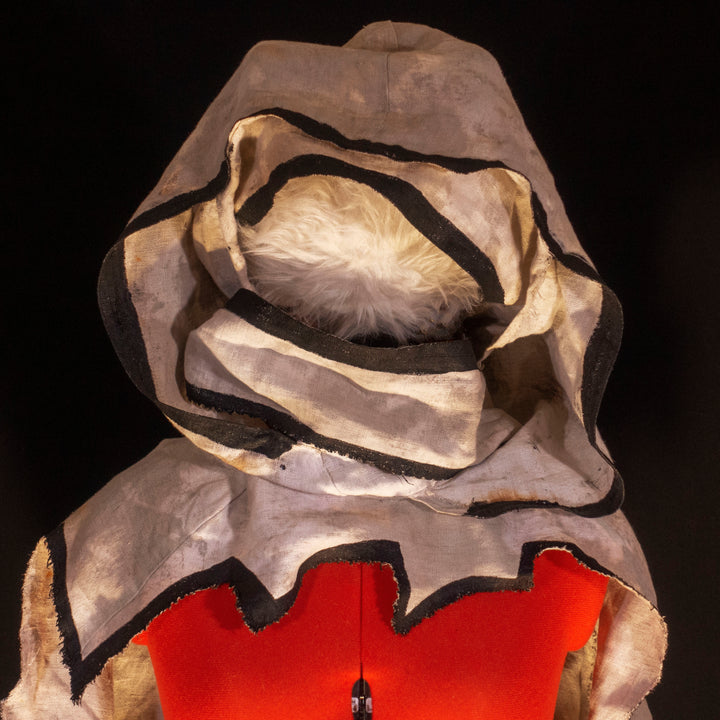 A Leper Cloak from Darkest Dungeon made demi-natte cotton canvas. Comes with the whole desaturated and cell shaded look!