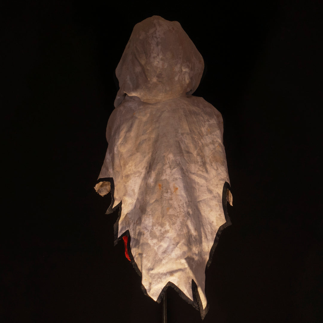 A Leper Cloak from Darkest Dungeon made demi-natte cotton canvas. Comes with the whole desaturated and cell shaded look!