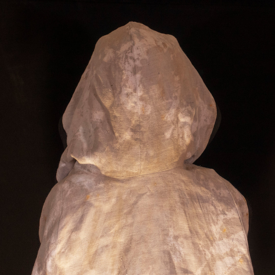 A Leper Cloak from Darkest Dungeon made demi-natte cotton canvas. Comes with the whole desaturated and cell shaded look!