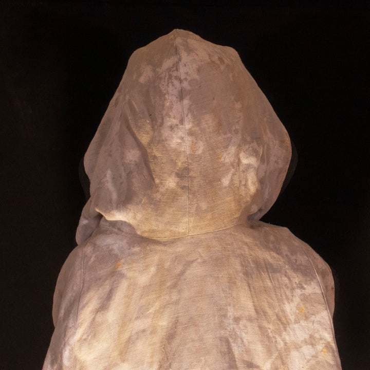 A Leper Cloak from Darkest Dungeon made demi-natte cotton canvas. Comes with the whole desaturated and cell shaded look!