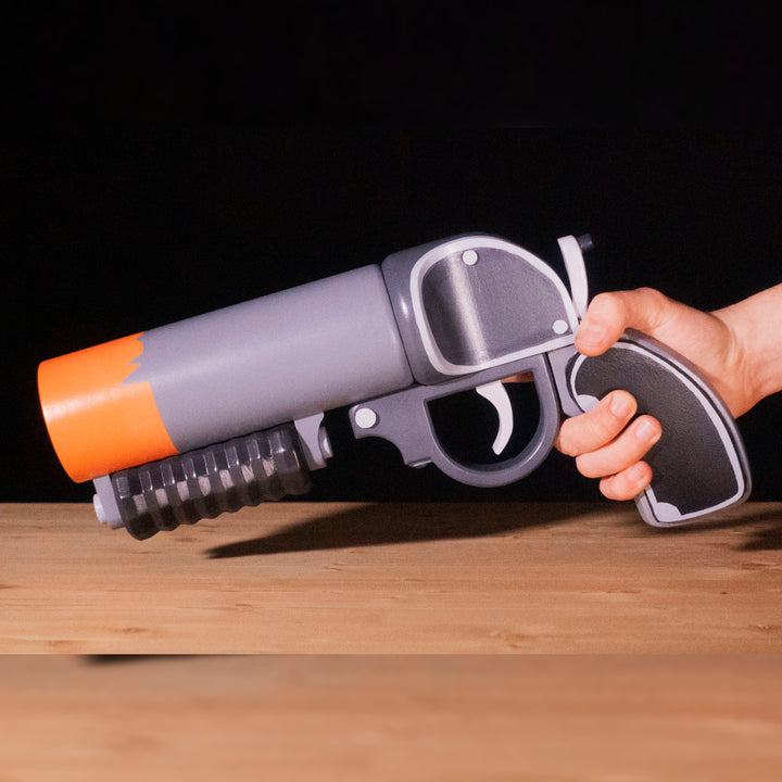 A TF2 Pyro Scorch Shot cosplay prop with its Team Fortress 2 paint job!